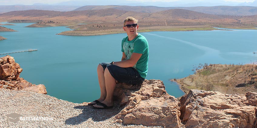 Boy Sitting on a Cliff